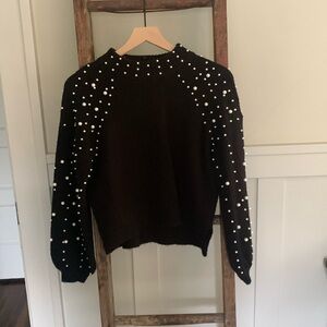 Black high neck sweater with pearl detail